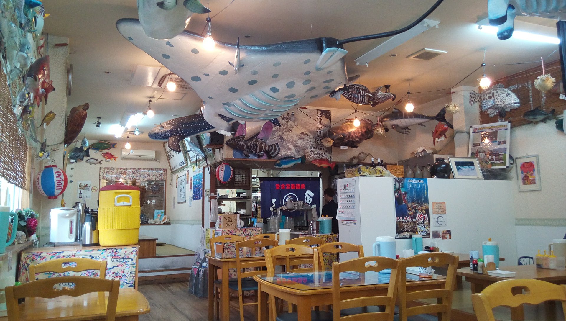 The inside of the shop is decorated with a lot of fish models